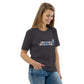 Model wearing the IRACELIKEAGIRL Stanley/Stella Creator unisex tee in Anthracite with the white and sky blue GIRLSGETGRITTY IRACELIKEAGIRL logo on the front
