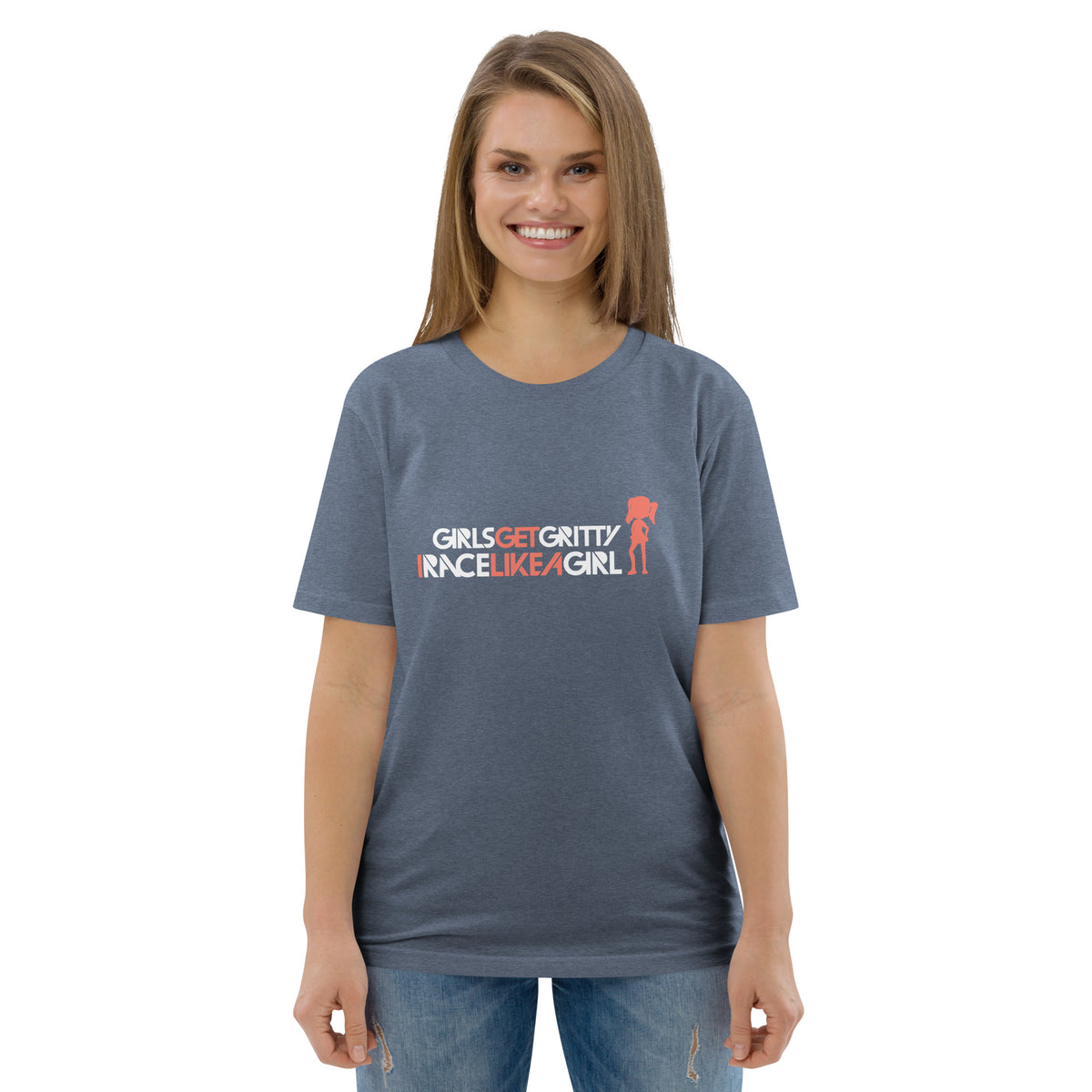 Model wearing the IRACELIKEAGIRL Stanley/Stella Creator unisex tee in Dark Heather Blue with the white and coral GIRLSGETGRITTY IRACELIKEAGIRL logo on the front